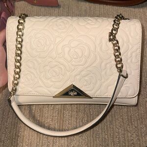 White Karl Lagerfeld Rose bag, with gold colored hardware and chain.